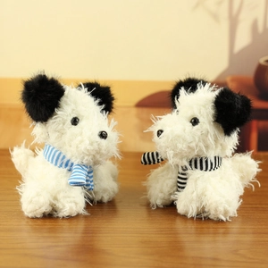 Close-up of two fluffy Westie plush toy dogs wearing striped knitted scarves on wood