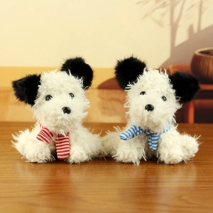 Close-up of Westie plush toy puppies with striped scarves and cute large black ears