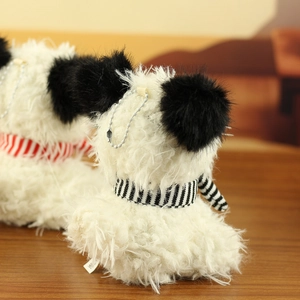 Macro detail of fluffy Westie plush keychain showing soft texture and striped scarf