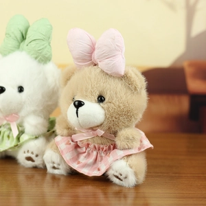 Detail of plush bear pendants featuring floral dresses and embroidered paw pads
