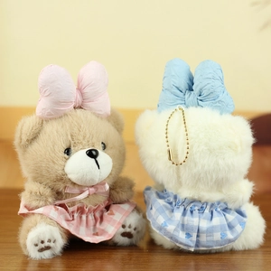 Detail of plush bear keychains showing textures, pink hearts, and blue checkered dresses