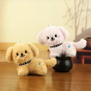 Close-up of soft plush puppy pendants with embroidery details and rainbow heart accents