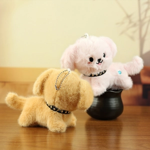 Close-up of pink and brown plush puppy keychains with soft fur and embroidered details