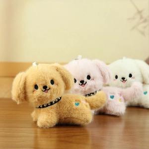 Detailed view of plush dog keychains in yellow, pink and white with leather collars