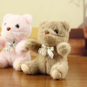 Detailed view of plush teddy bear charms with satin bowknot and pearl pendant accessories