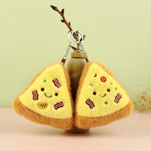Close-up of cute plush pizza keychains featuring smiling faces and soft fabric textures