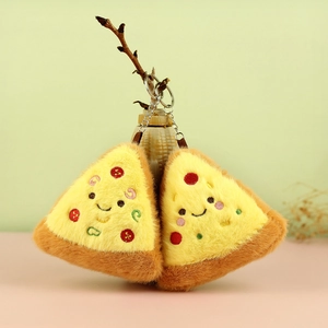 Detail of two plush pizza slice pendants with cute embroidery and metal keychains