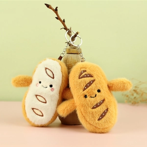 Close-up of cute plush bread keychains with silver metal rings on a soft pastel background