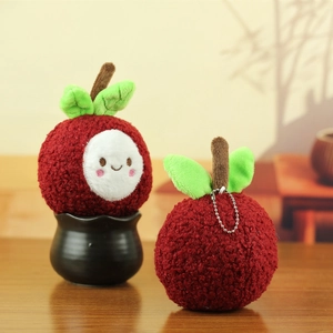 Detailed view of two plush mangosteen doll keychains with soft fabric and metal chains