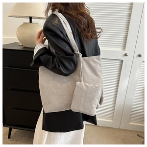 Detail of striped corduroy tote bag set with small matching pouch in beige grey