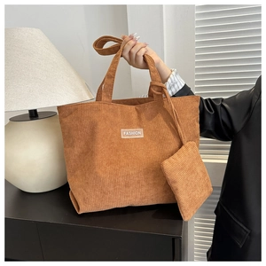 Detailed corduroy texture of large tote bag with matching pouch and fashion label