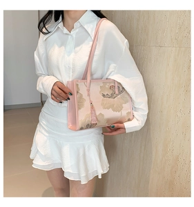 Detail of pink floral silk tote bag featuring elegant peony prints and a silk tassel