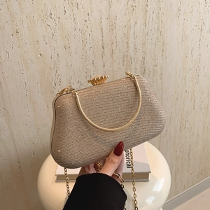 Elegant gold glitter evening clutch bag with metal handle and crossbody chain strap
