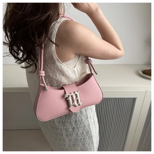 Detail of pink baguette bag with silver gothic M buckle and knotted shoulder strap