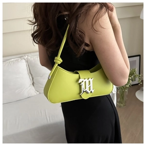 Detail of lime green baguette bag with large silver M buckle and knotted shoulder strap