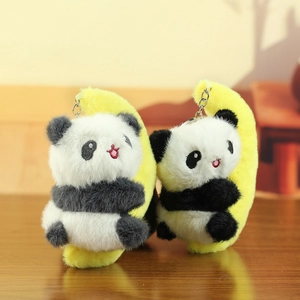 Detailed close-up of cute panda plush keychain on yellow moon with soft faux fur texture