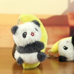 Close-up of cute plush panda keychain holding a banana with fluffy texture details