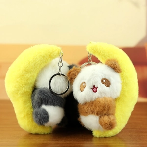 Detail of plush panda moon keychains in grey and brown featuring soft velvet textures
