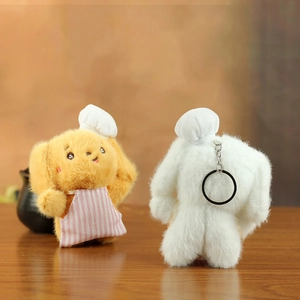 Detailed view of plush puppy chefs with hats and aprons on a natural wood surface
