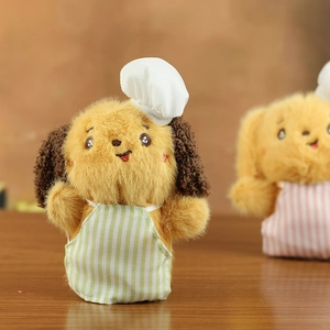 Detail of plush puppy keychain wearing a white chef hat and green striped apron