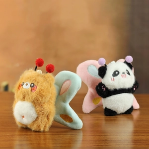 Close-up of plush bear and panda charms with soft faux fur and embroidered wings