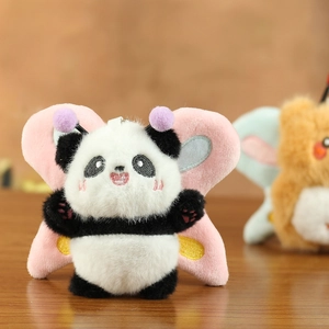 Detail of cute panda plush keychain with pink butterfly wings and soft fur texture