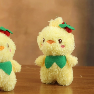 Close-up of yellow plush chick pendant with red berry decor and green neck scarf