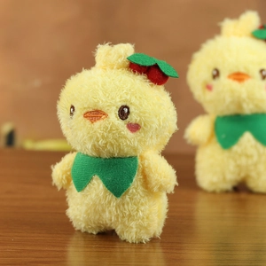 Close-up of yellow plush duckling keychain with cherry decor and embroidered details