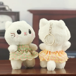Front and back detail of plush cat keychains with floral lace dresses and embroidery