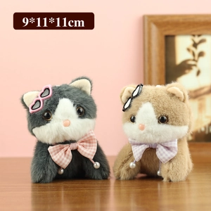 Cute plush cat keychain with sunglasses and plaid bow tie on pink background