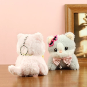 Detail of plush cat keychains with heart sunglasses and pink checkered bow ties