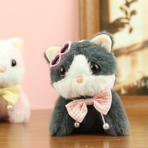 Detail of plush cat charm with heart sunglasses and pink checkered bowtie accessory