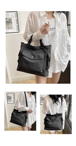 Détail d'un grand sac cabas noir en toile montrant les options de port à main et en bandoulière