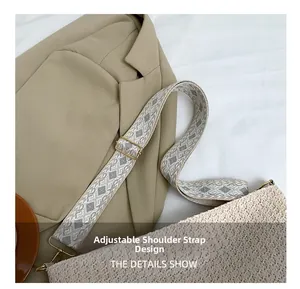 Detail of adjustable geometric jacquard shoulder strap on beige woven bag