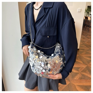 Detail view of shiny silver sequin shoulder bag with elegant metal chain strap for women