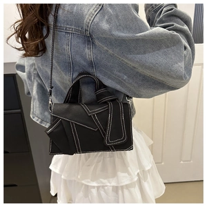 Black denim crossbody bag with contrast stitching and knotted strap detail for women