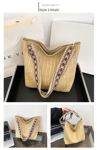 Detail of khaki straw hobo bag with ethnic geometric strap and woven texture