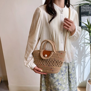 French style straw bucket bag with ribbon bow and pearl buckle detail on leather flap