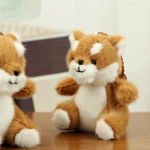 Close-up of cute plush fox pendant with soft brown fur and small backpack accessory