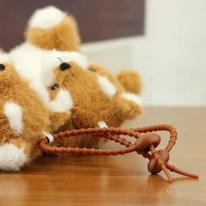 Close-up of the soft plush material and adjustable brown drawstring on Shiba Inu accessory
