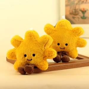 Detail of plush sun and star charms with corduroy legs on a vintage wooden frame