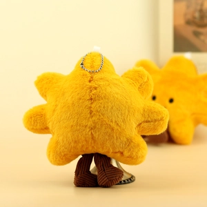 Detail of yellow star plush keychain featuring corduroy legs and a metal bead chain