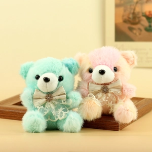 Simpatici orsetti di peluche verde menta e arancione con fiocchi di pizzo su cornice