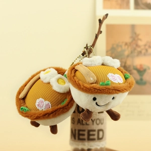 Close-up of cute plush noodle bowl keychains with embroidered faces and realistic toppings