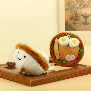 Detail of plush noodle bowl and rice bowl keychains with golden bead chains