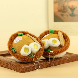 Close-up of cute plush noodle bowl keychains with embroidered egg and green onion detail