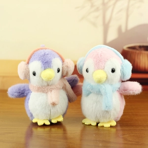 Cute plush penguin keychains in pink and purple colors with winter ear muffs and scarves