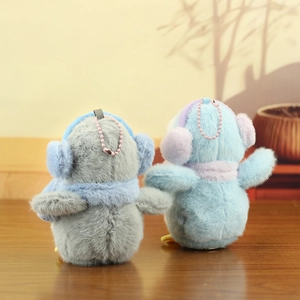 Detail view of penguin plush keychains with soft faux fur and pink metal bead chains