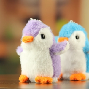 Detailopname van schattige paarse en blauwe pluche pinguïn sleutelhangers van bont