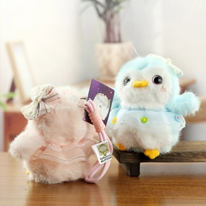 Plush penguin keychain pair in pink and blue with lace bows and tulle skirts